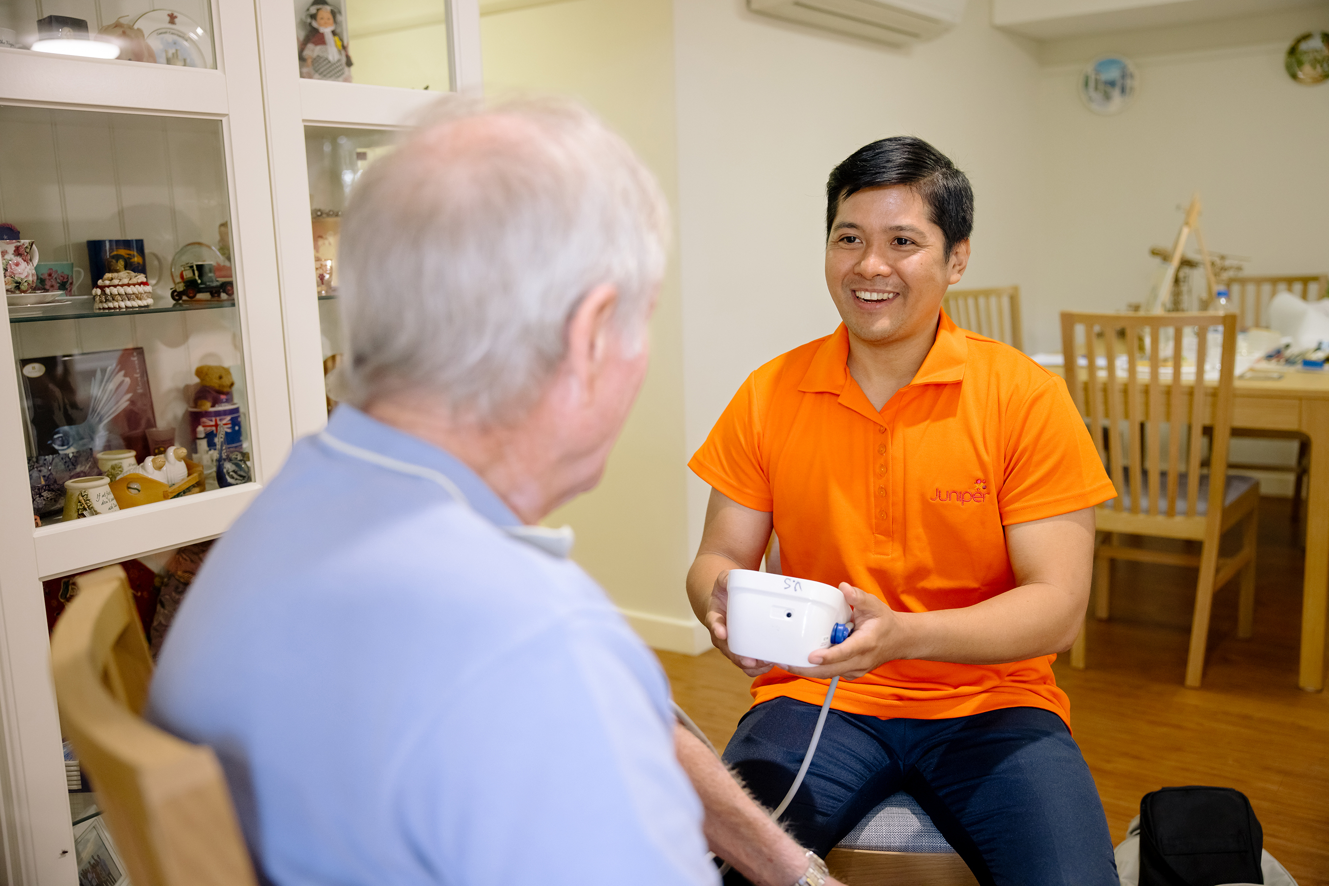 Male nurse checks blood pressure of a resident.